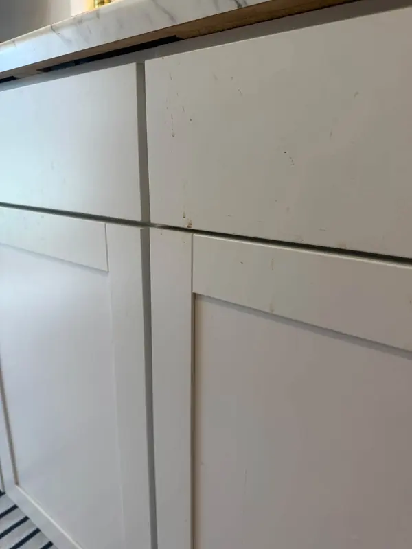 Cabinet edges before, with the dirt