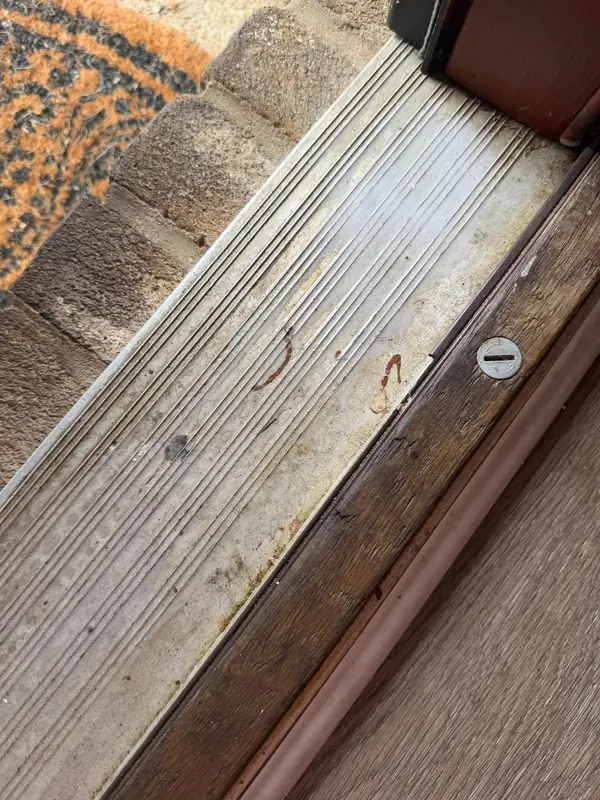 Door threshold before, with the dirt