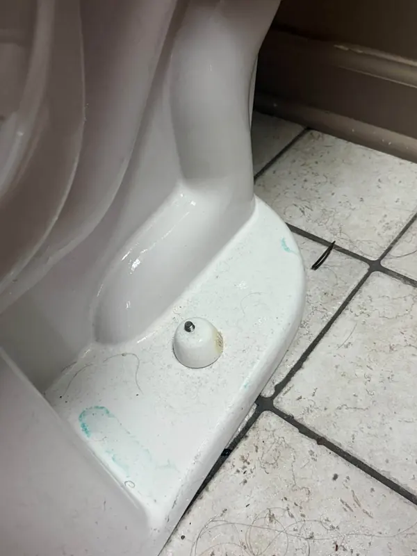 Behind the toilet before, with the dirt